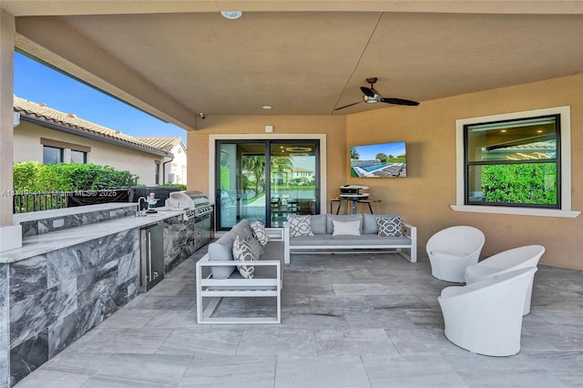 view of patio featuring sink, area for grilling, ceiling fan, and exterior kitchen