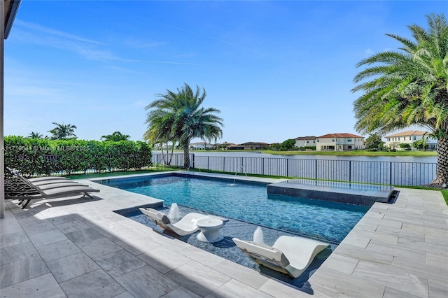 view of swimming pool with pool water feature, a water view, and a patio