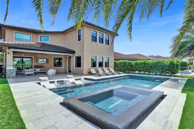 rear view of house with an outdoor hangout area, pool water feature, ceiling fan, a swimming pool with hot tub, and a patio