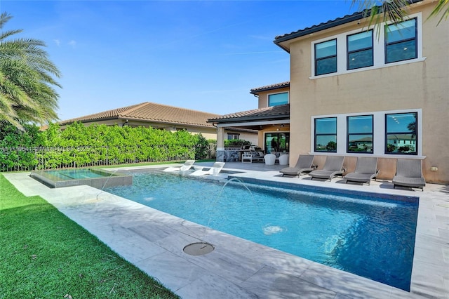 view of pool featuring pool water feature and a patio