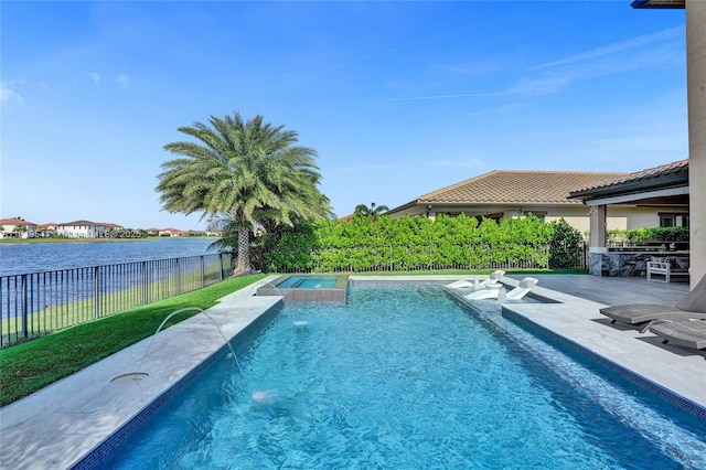 view of pool featuring an in ground hot tub, pool water feature, a water view, and a patio