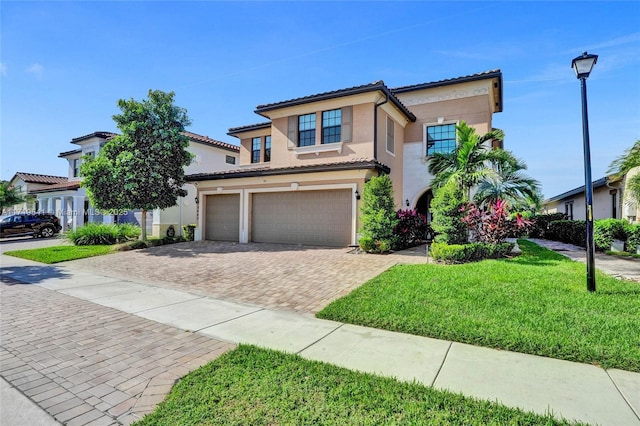 mediterranean / spanish-style home with a front yard and a garage