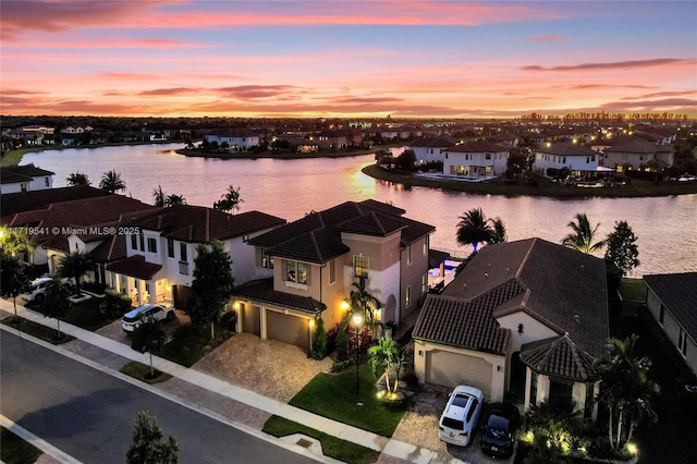 aerial view at dusk with a water view