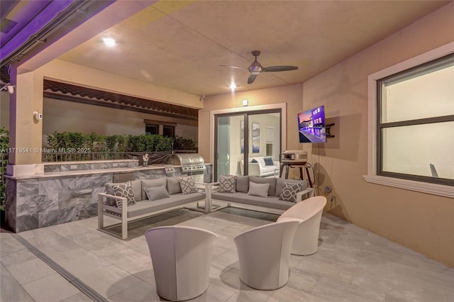 view of patio with ceiling fan, an outdoor living space, grilling area, and exterior kitchen