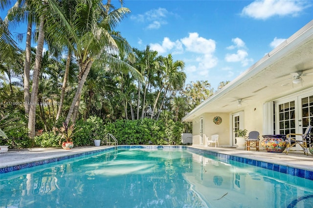 view of pool with ceiling fan and a patio area