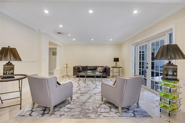 living room featuring crown molding, french doors, and decorative columns