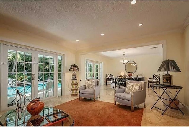 living room with a textured ceiling and french doors