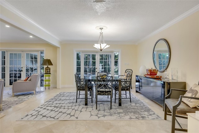 dining room featuring a textured ceiling, ornamental molding, and french doors