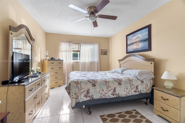 tiled bedroom featuring ceiling fan and a textured ceiling