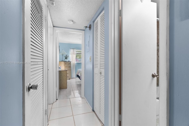 corridor with light tile patterned flooring