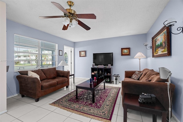 tiled living room with ceiling fan and a textured ceiling