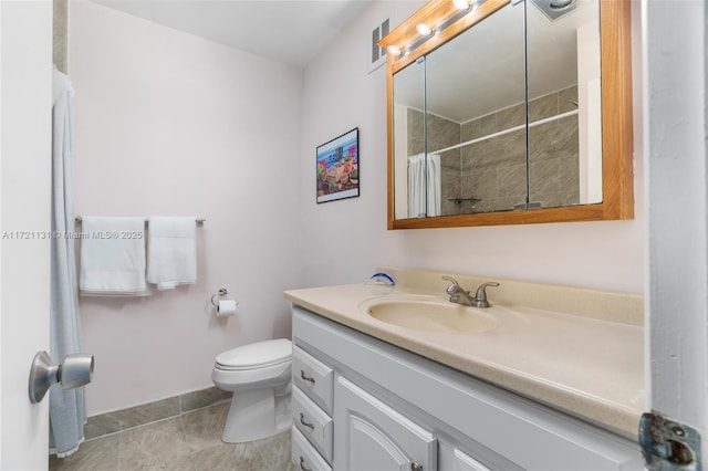 bathroom with tile patterned flooring, vanity, curtained shower, and toilet