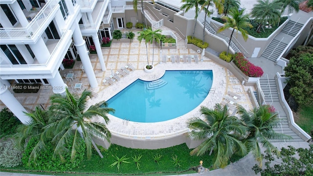 community pool featuring a patio area and stairs