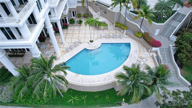 community pool featuring a patio and fence