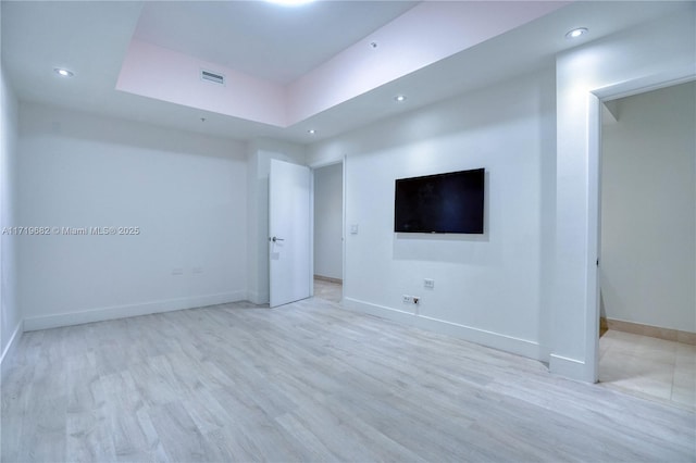 spare room with recessed lighting, visible vents, light wood-style flooring, and baseboards