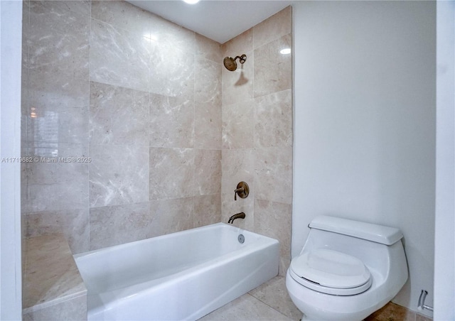 bathroom featuring toilet, shower / washtub combination, and tile patterned floors