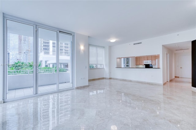 unfurnished living room featuring marble finish floor, baseboards, and visible vents