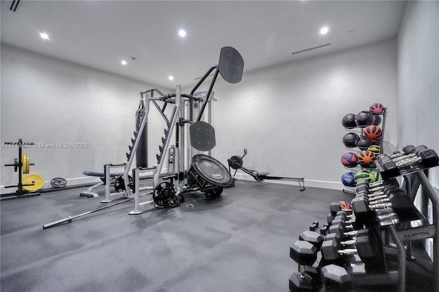 gym with baseboards and recessed lighting