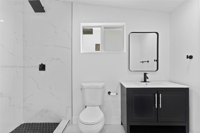 bathroom with vanity, toilet, and tiled shower