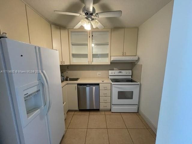 kitchen featuring ceiling fan, white appliances, and light tile patterned floors