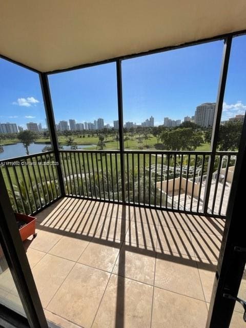 unfurnished sunroom featuring a water view