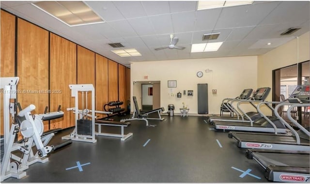 exercise room featuring a paneled ceiling and ceiling fan