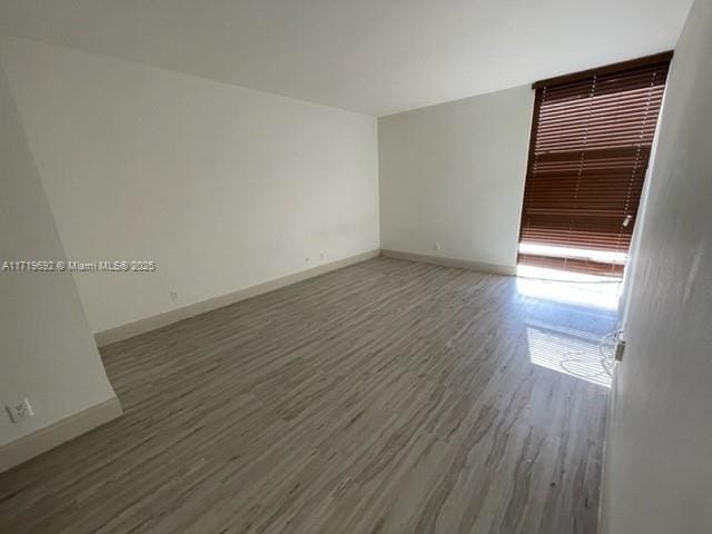 spare room featuring dark hardwood / wood-style flooring