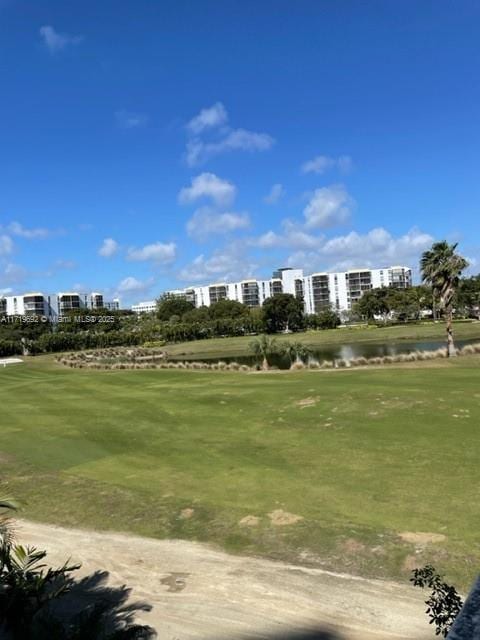 view of community featuring a lawn and a water view