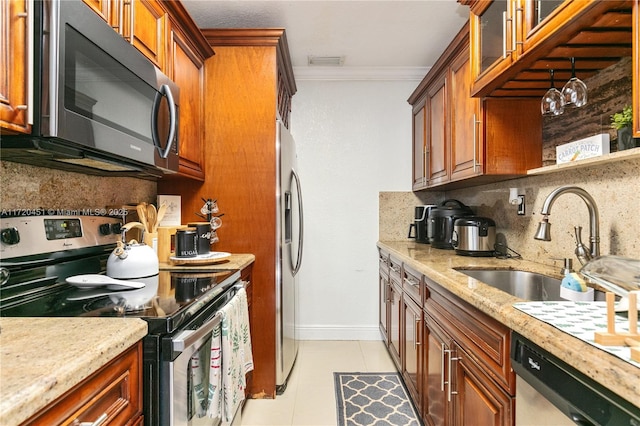 kitchen featuring tasteful backsplash, stainless steel appliances, crown molding, sink, and light tile patterned floors