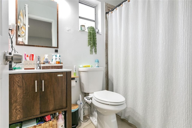 bathroom with walk in shower, vanity, and toilet