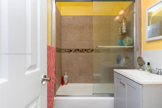 bathroom featuring vanity and shower / bath combination with glass door