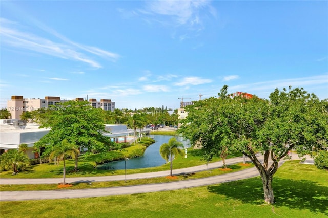 view of property's community featuring a water view and a yard