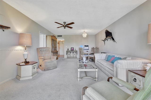 carpeted living room with a textured ceiling and ceiling fan