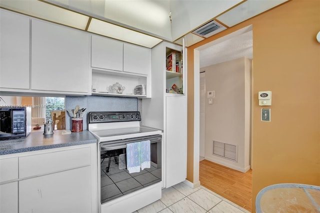 kitchen featuring white cabinetry and white range with electric stovetop