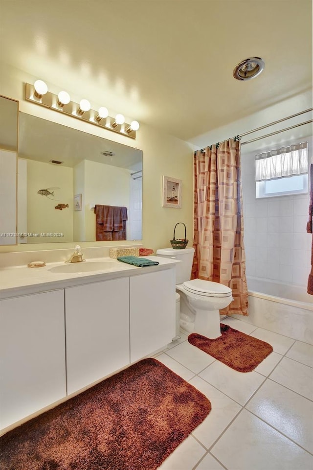 full bathroom with tile patterned flooring, shower / tub combo, vanity, and toilet