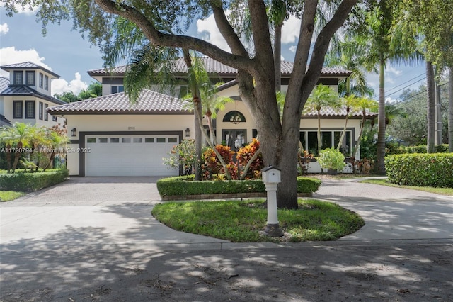 mediterranean / spanish-style home with a garage