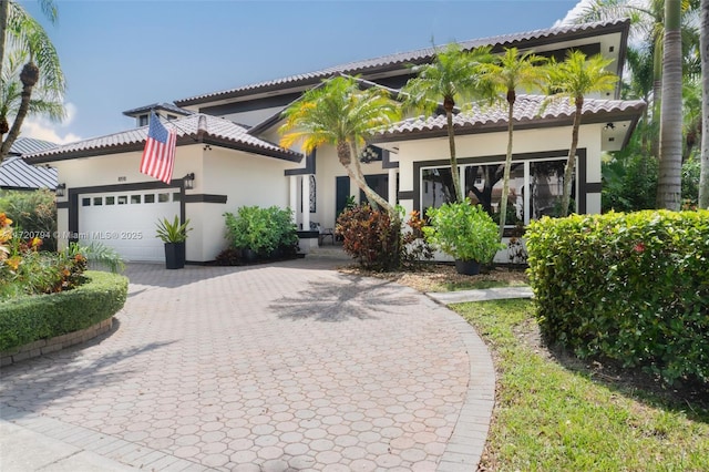 mediterranean / spanish-style home with a garage