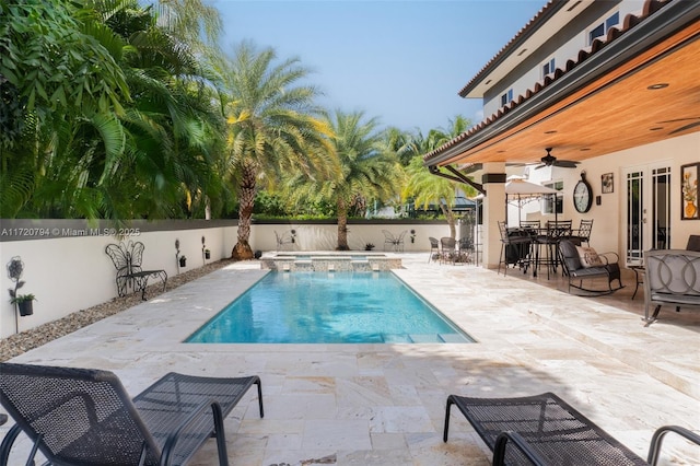 view of pool featuring an in ground hot tub, ceiling fan, and a patio area