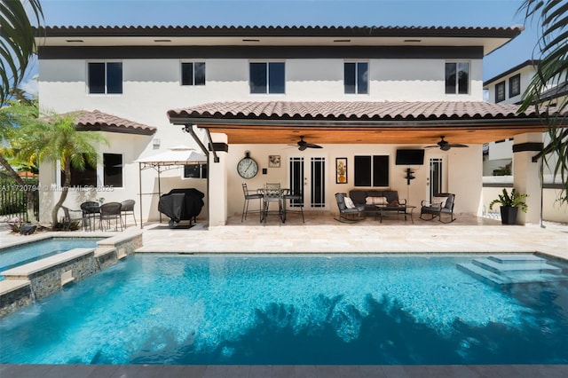 back of property featuring outdoor lounge area, a swimming pool with hot tub, ceiling fan, and a patio area