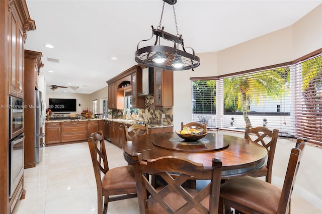 tiled dining space with ceiling fan