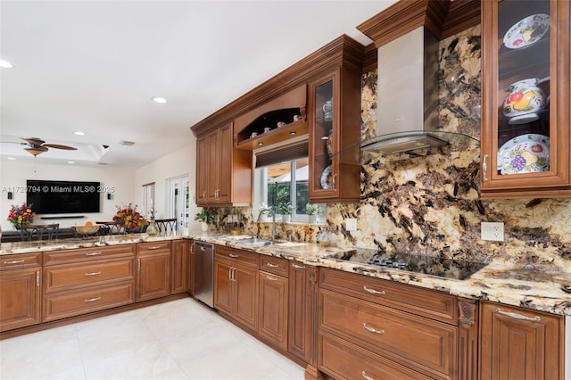 kitchen featuring light stone countertops, dishwasher, wall chimney exhaust hood, sink, and black electric stovetop