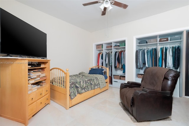 bedroom featuring ceiling fan and two closets