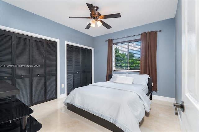 bedroom with ceiling fan and multiple closets