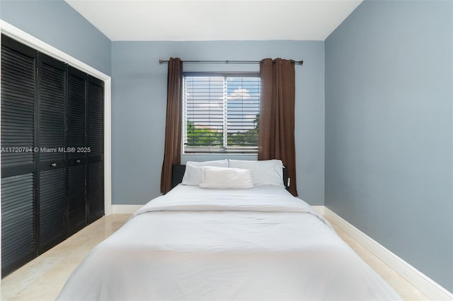 bedroom with hardwood / wood-style floors and a closet