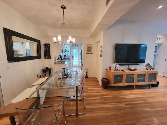 dining room with a chandelier and wood-type flooring