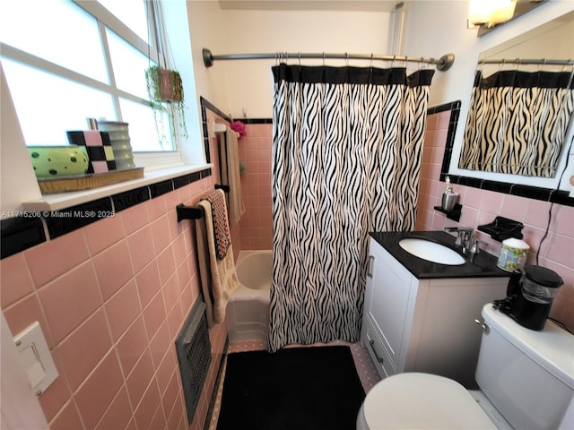 full bathroom featuring vanity, shower / bath combination with curtain, tile walls, and toilet