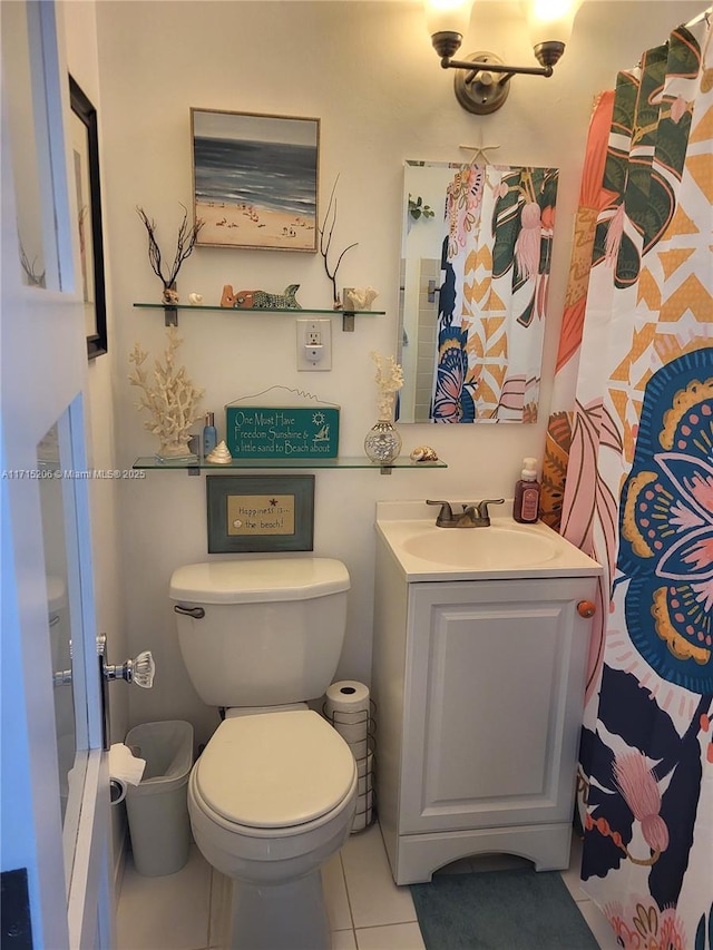 bathroom featuring tile patterned flooring, vanity, and toilet