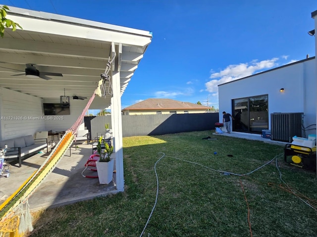 view of yard featuring a patio area, ceiling fan, and central AC unit