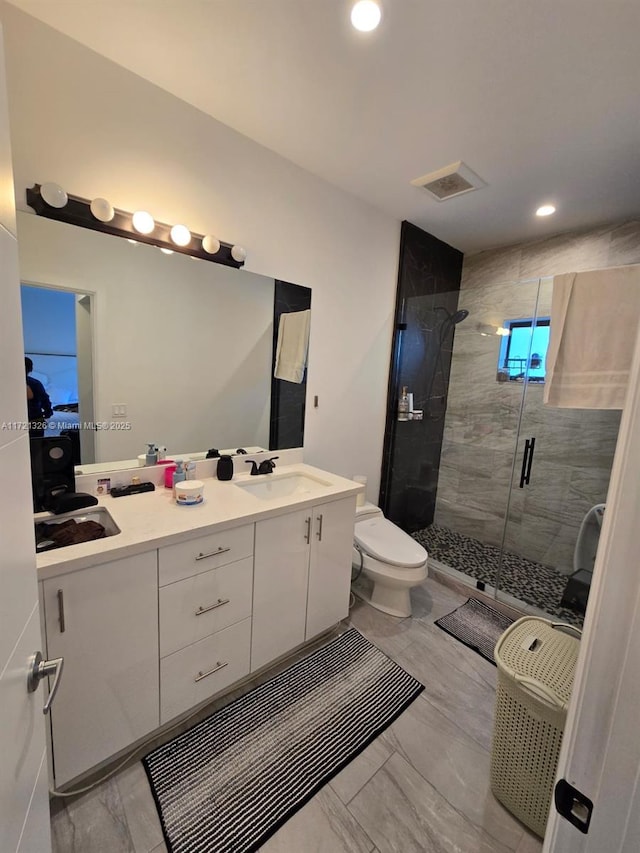 bathroom with vanity, toilet, and an enclosed shower