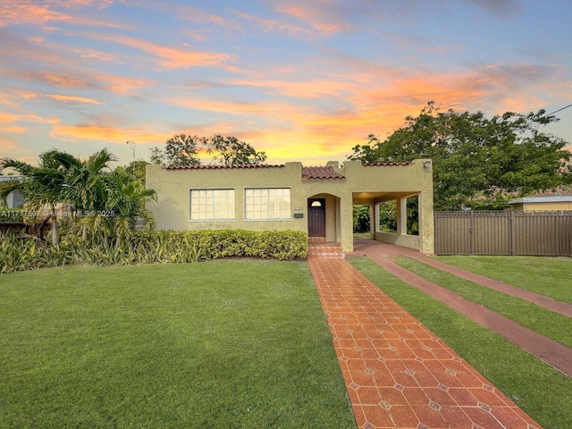 mediterranean / spanish home with a yard